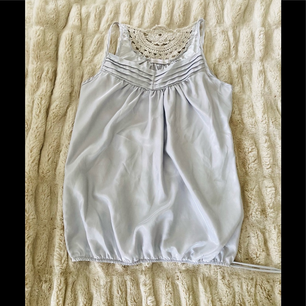 Sleeveless baby blue silky top with tie bottom